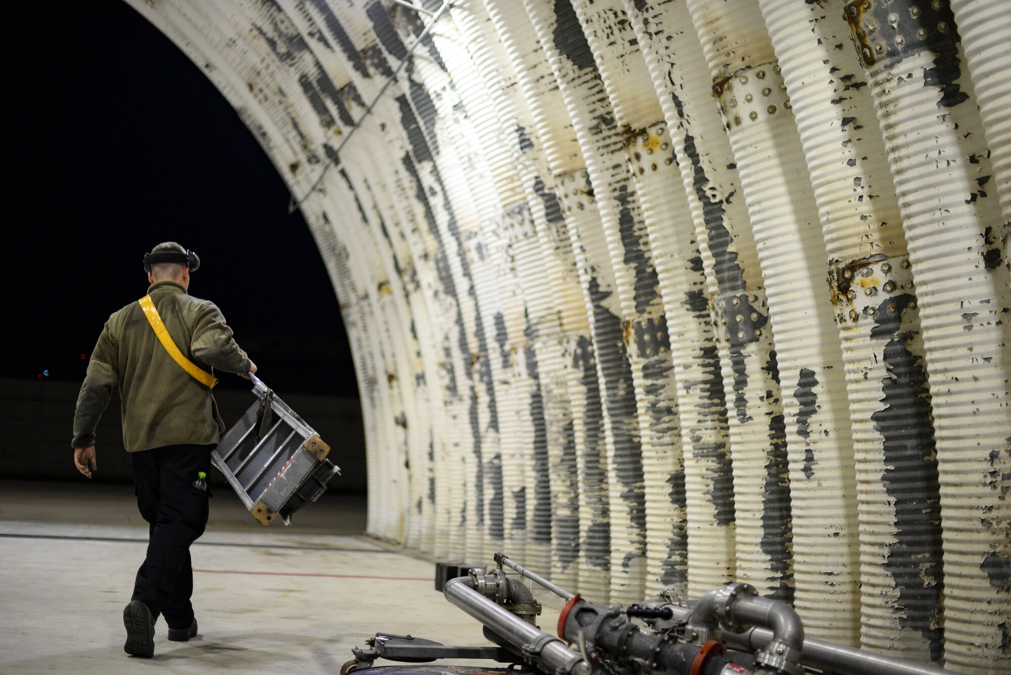 An Airman carries a ladder.