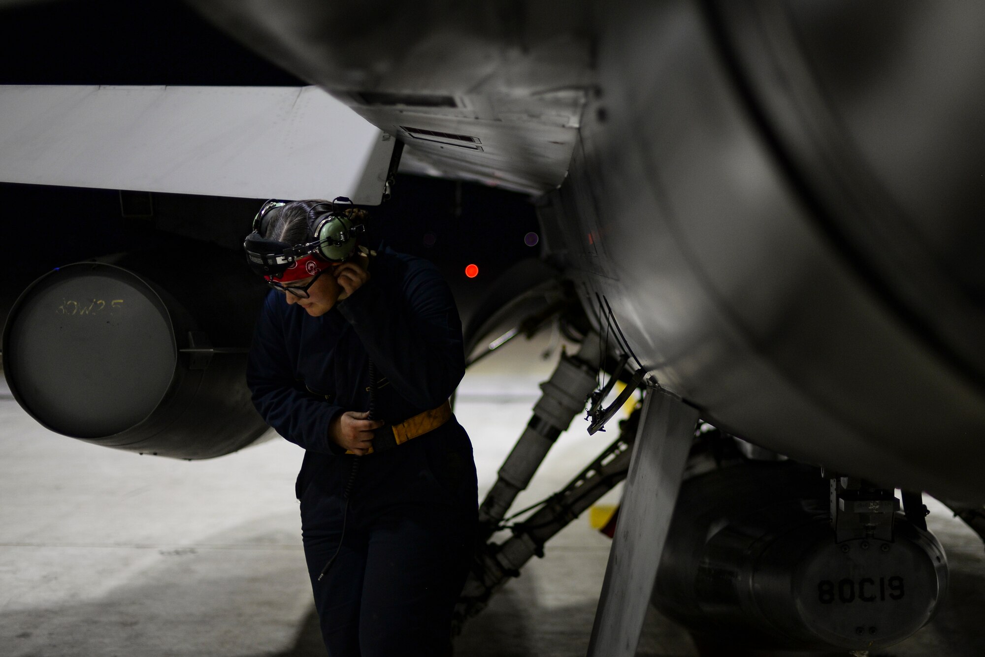 An Airman performs an inspection on a jet.