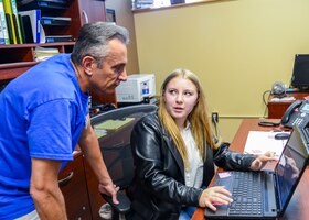 Kierstin Baldwin, a junior at Desert Junior-Senior High School on base, discusses her submission for the 2021 California Boys and Girls Clubs Military Youth of the Year competition with Paul La Bella, teen coordinator at Edwards AFB. Baldwin won the statewide competition and received a $2,500 scholarship recently. (Air Force photo by Gary Hatch)