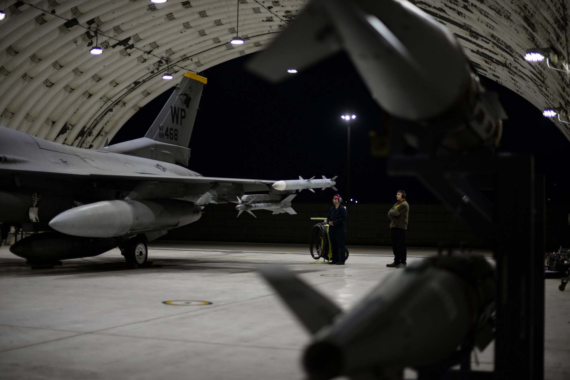 Airmen prepare a jet for flight.