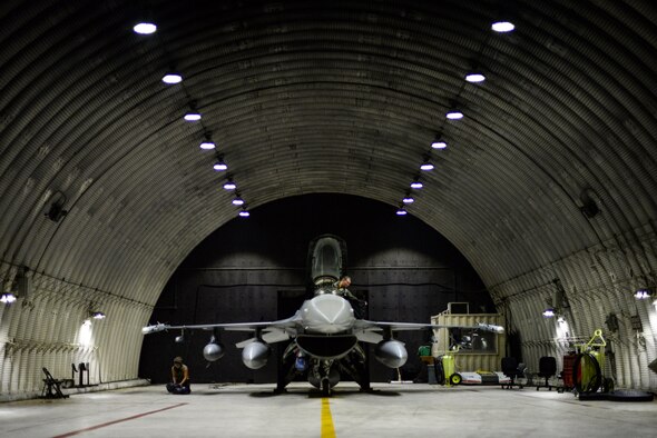 Airmen prepare a jet for flight.