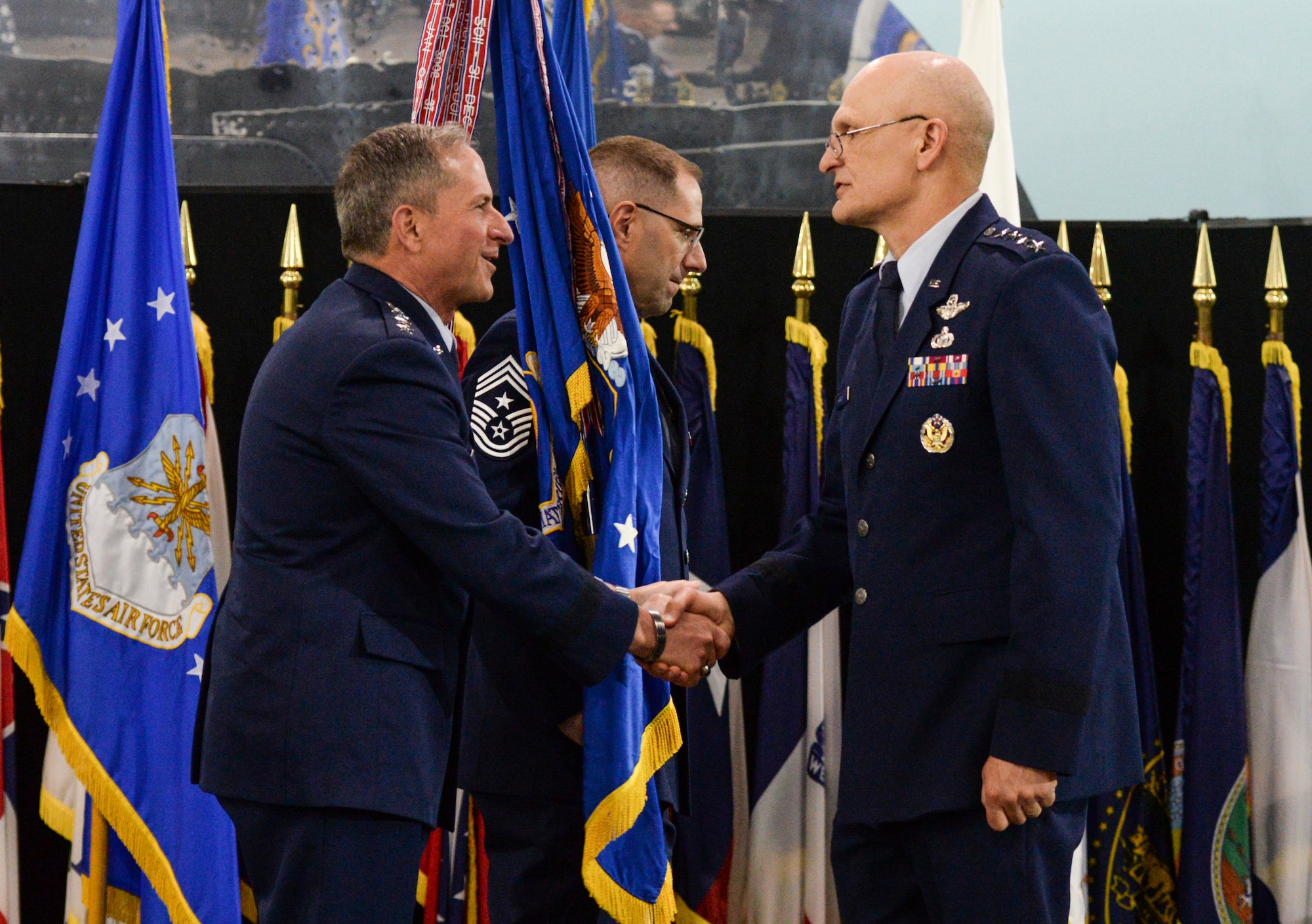 Air Force Chief of Staff Gen. David L. Goldfein congratulates Gen. Arnold W. Bunch, Jr. after assuming command of Air Force Materiel Command commander, shake hands during an assumption of command ceremony inside the National Museum of the United States Air Force, Wright-Patterson Air Force Base, Ohio, May 31, 2019. AFMC manages the research, development, acquisition, test and logistics services that keep Air Force weapon systems and warfighters ready for combat. (U.S. Air Force photo by Wesley Farnsworth)
