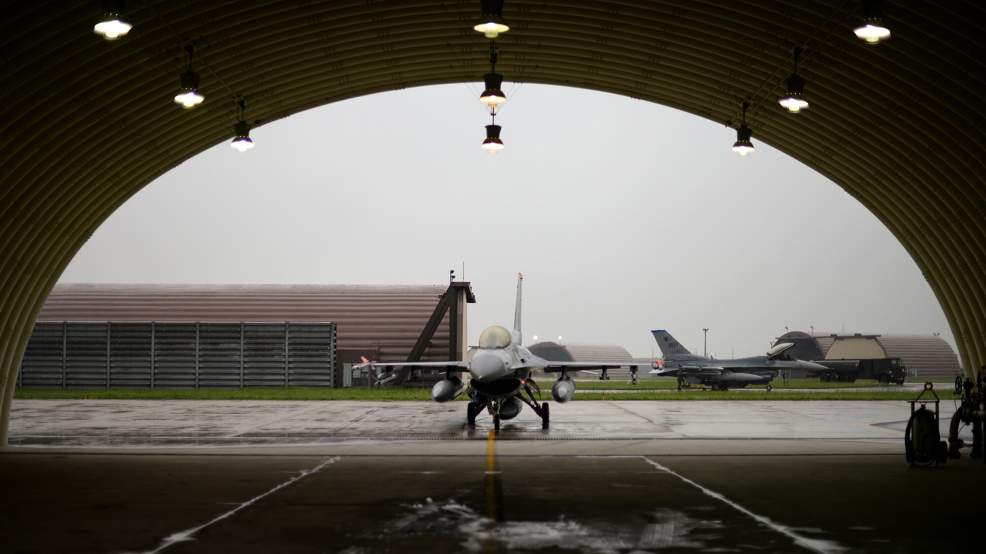 A jet taxis into a shelter.