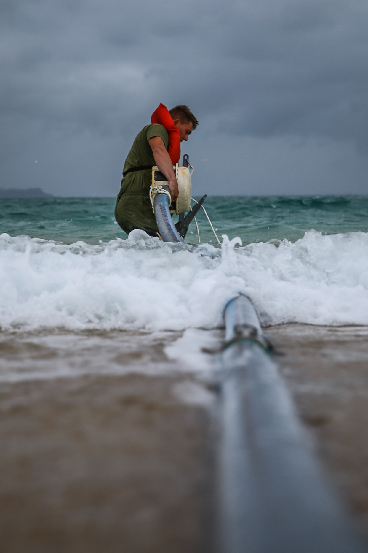 U.S. Marine Corps Cpl. Joseph Dixon, water support technician with 9th Engineer Support Battalion, 3d Marine Logistics Group, adjusts the placement of an anchor to secure a Dolphin Strainer during exercise Pacific Pioneer, Okinawa, Japan, April 21, 2021. Pacific Pioneer serves as 9th ESB's Marine Corps Combat Readiness Evaluation as well as an opportunity to demonstrate the ability to establish and sustain expeditionary advanced bases with survivable force protection, practice naval integration, and position long range precision fires and tactical logistics nodes across littoral regions in support of naval operations. 3d MLG, based out of Okinawa, Japan, is a forward deployed combat unit that serves as III MEF’s comprehensive logistics and combat service support backbone for operations throughout the Indo-Pacific area of responsibility. Dixon is a native of Hibbing, Minnesota. (U.S. Marine Corps photo by Sgt. Hailey D. Clay)
