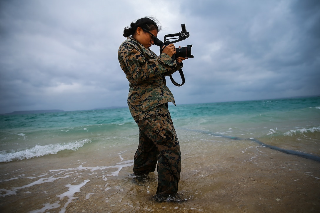 U.S. Marine Corps Lance Cpl. Alpha Hernandez, combat videographer with Communication Strategy and Operations, 3d Marine Logistics Group, documents water support technicians pumping ocean water to purify it into drinkable water during exercise Pacific Pioneer, Okinawa, Japan, April 21, 2021. Pacific Pioneer serves as 9th ESB's Marine Corps Combat Readiness Evaluation as well as an opportunity to demonstrate the ability to establish and sustain expeditionary advanced bases with survivable force protection, practice naval integration, and position long range precision fires and tactical logistics nodes across littoral regions in support of naval operations. 3d MLG, based out of Okinawa, Japan, is a forward deployed combat unit that serves as III MEF’s comprehensive logistics and combat service support backbone for operations throughout the Indo-Pacific area of responsibility. Hernandez is a native of Houston, Texas. (U.S. Marine Corps photo by Sgt. Hailey D. Clay)