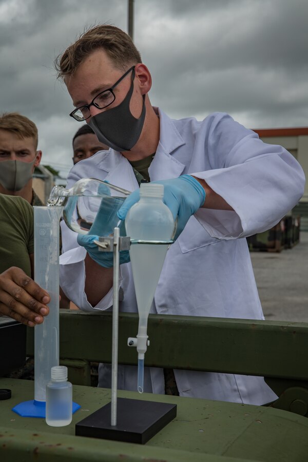 U.S. Marine Corps Lance Cpl. Cole Kessinger, a bulk fuel specialist with Bulk Fuel Company, 9th Engineer Support Battalion, 3d Marine Logistics Group (MLG), injects fuel additives into fuel during an Expeditionary Mobile Fuel Additization Capability (EMFAC) equipment training at Camp Hansen, Okinawa, Japan, May 12, 2021. Bulk fuel Marines implement the new EMFAC system into advanced training to better enable forward maneuver elements, proficiency and speed into future operations in the Indo-Pacific area of operations. 3d MLG, based out of Okinawa, Japan, is a forward deployed combat unit that serves as III MEF’s comprehensive logistics and combat service support backbone for operations throughout the Indo-Pacific area of responsibility. (U.S. Marine Corps photo by Lance Cpl. Courtney A. Robertson)