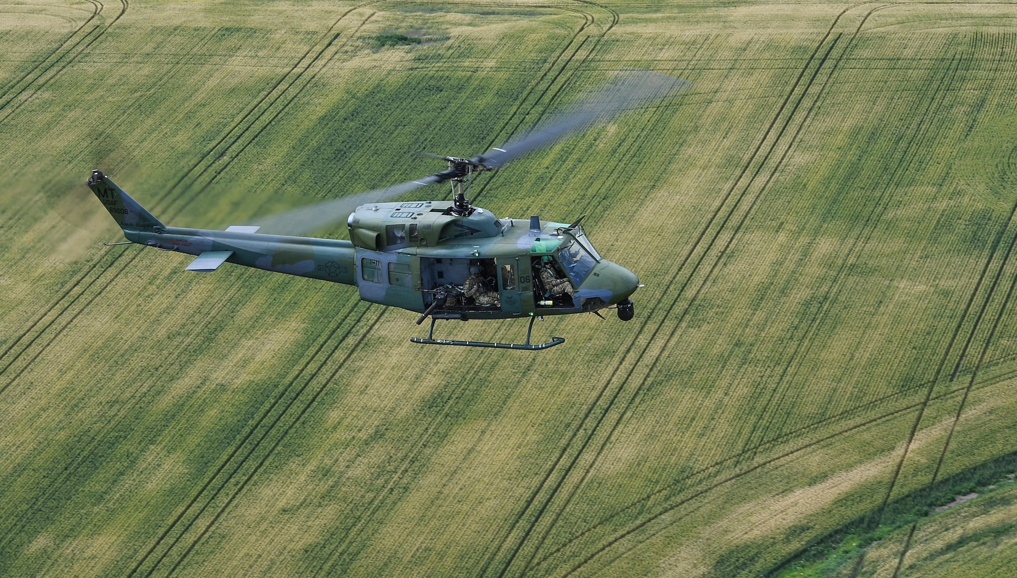 Members of the 54th Helicopter Squadron fly near Minot Air Force Base, North Dakota, July 26, 2018. Members of the unit provide convoy support, missile complex security and maintain aircrew flight proficiency. (U.S. Air Force photo by Senior Airman Jonathan McElderry)