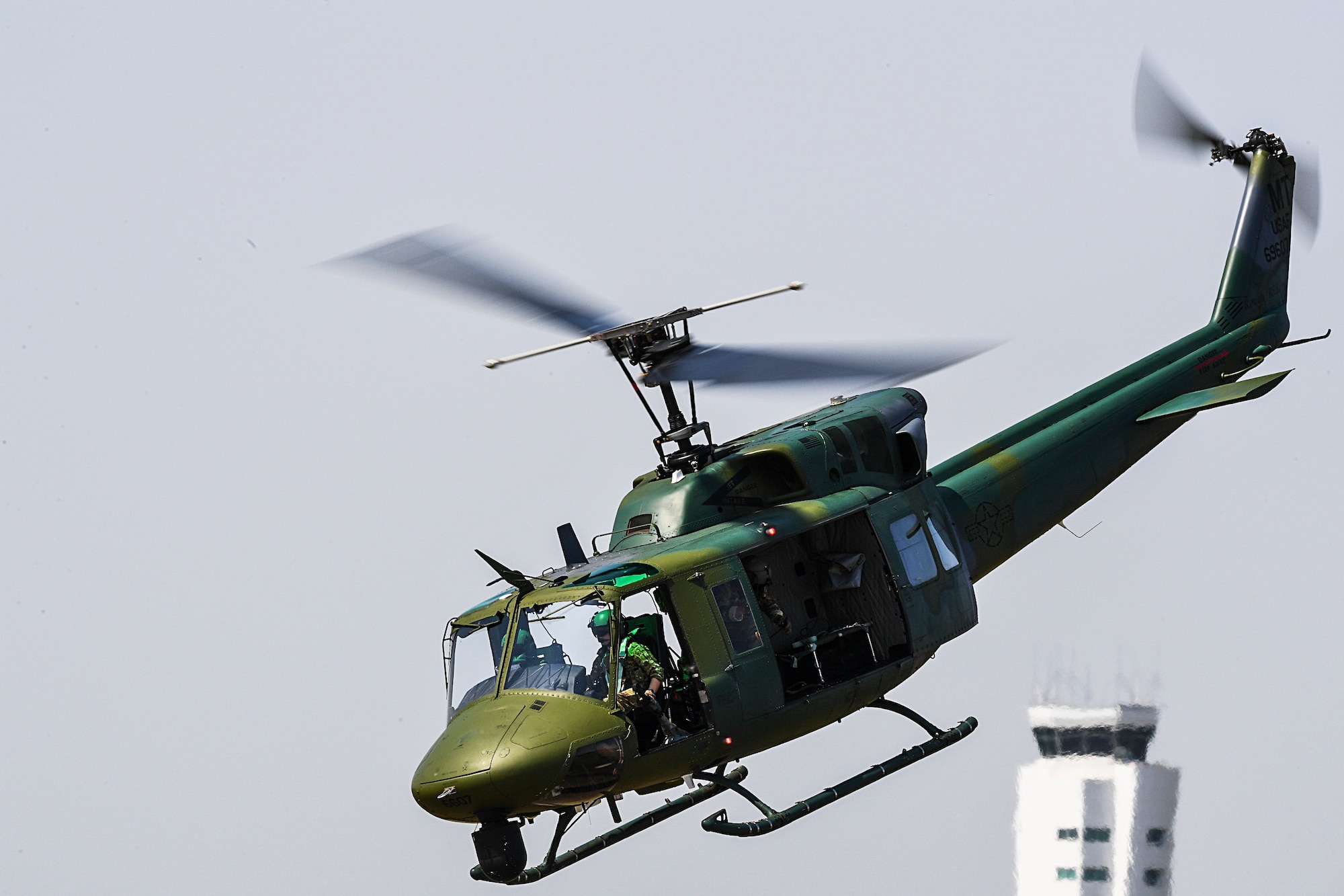 Members of the 54th Helicopter Squadron fly above the flightline during the Northern Neighbors Day Air and Space Show at Minot Air Force Base, North Dakota, Aug. 4, 2018. The event featured aerial demonstrations by the U.S. Air Force Thunderbirds, Carlton Glider, B-25 Mitchell, T-33 Acemaker and more. (U.S. Air Force photo by Senior Airman Jonathan McElderry)