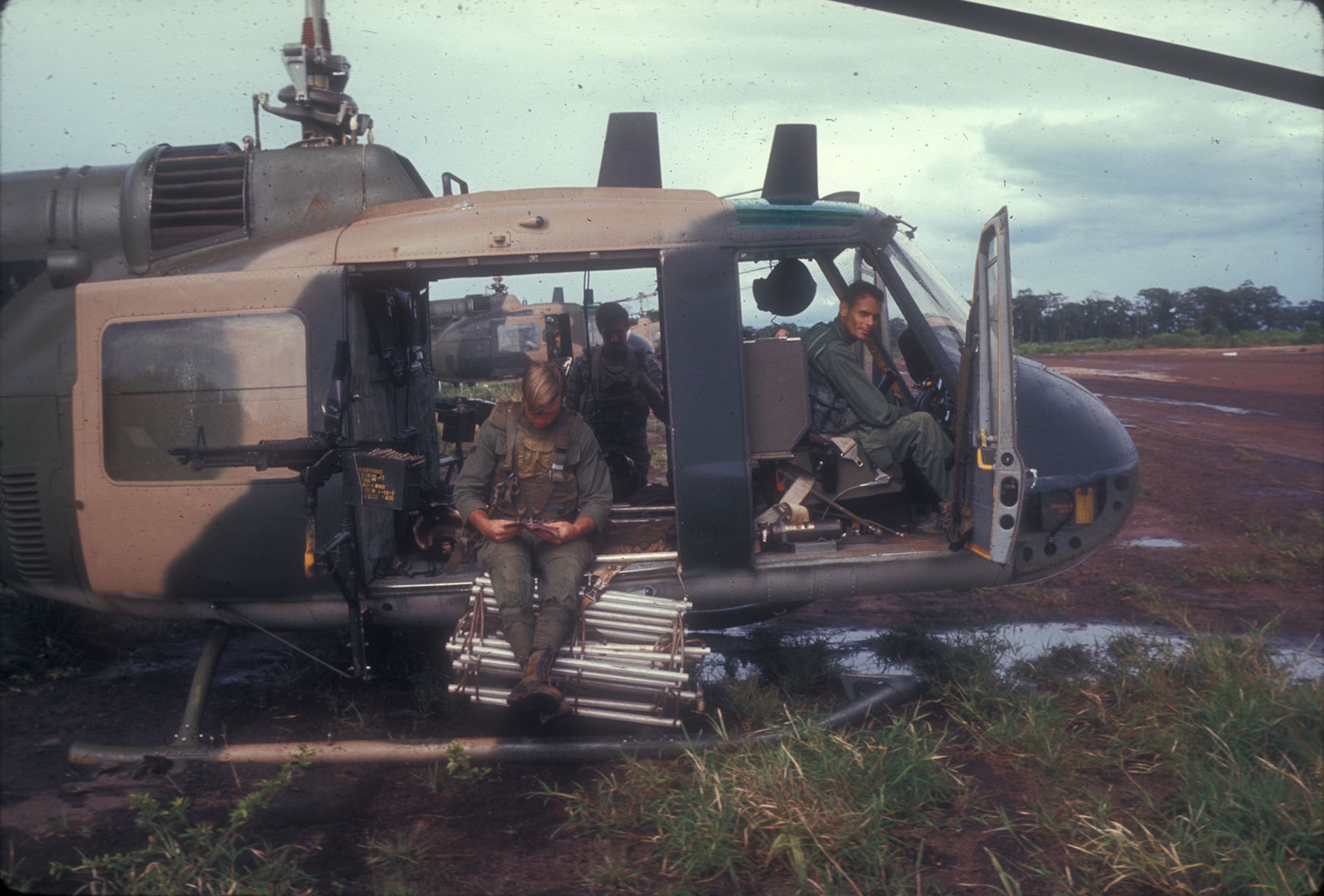 A UH-1 crew armed and ready for a covert mission. Notice the flexible ladder that could be extended to pick up personnel when the helicopter could not land. (U.S. Air Force photo)