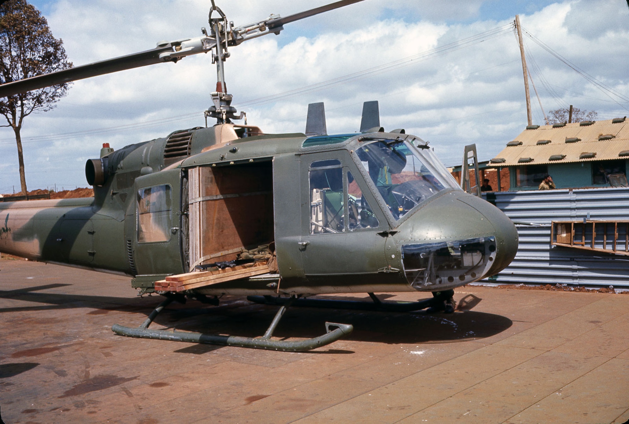 Pony Express missions carried just about anything to support the secret missions and radar sites in Laos. This Green Hornet UH-1 at the forward operation location at Duc Lap, South Vietnam, is hauling lumber and plywood sheets. (U.S. Air Force photo)