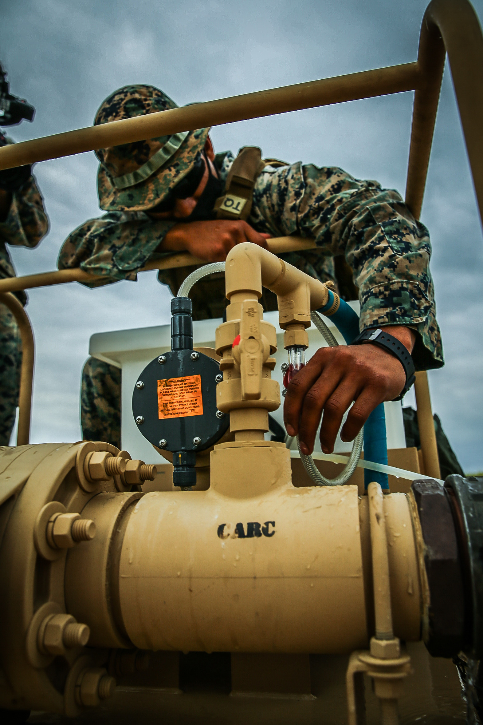 U.S. Marine Corps Cpl. Kevin Galaz, water support technician with 9th Engineer Support Battalion, 3d Marine Logistics Group, monitors a hypochlorination unit, circulating appropriate levels of chlorine through purified ocean water to kill bacteria in a water tank during exercise Pacific Pioneer, Okinawa, Japan, April 21, 2021. Pacific Pioneer serves as 9th ESB's Marine Corps Combat Readiness Evaluation as well as an opportunity to demonstrate the ability to establish and sustain expeditionary advanced bases with survivable force protection, practice naval integration, and position long range precision fires and tactical logistics nodes across littoral regions in support of naval operations. 3d MLG, based out of Okinawa, Japan, is a forward deployed combat unit that serves as III MEF’s comprehensive logistics and combat service support backbone for operations throughout the Indo-Pacific area of responsibility. (U.S. Marine Corps photo by Sgt. Hailey D. Clay)