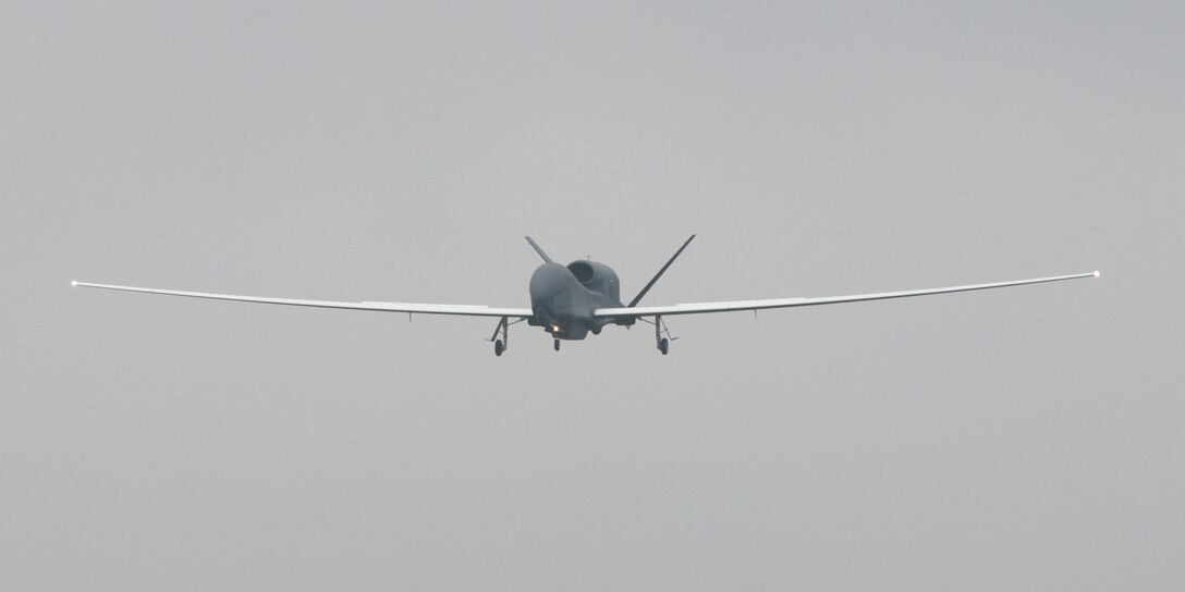 An RQ-4 Global Hawk, assigned to the 4th Reconnaissance Squadron, 319th Operation Group, Andersen Air Force Base, Guam, approaches at Yokota Air Base, Japan, May, 22, 2021, for a rotational deployment. The movement maintains operations for Global Hawks during months of inclement weather on Guam. (U.S. Air Force photo by Yasuo Osakabe)