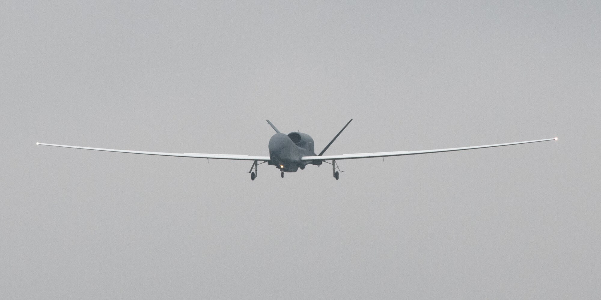 An RQ-4 Global Hawk, assigned to the 4th Reconnaissance Squadron, 319th Operation Group, Andersen Air Force Base, Guam, approaches at Yokota Air Base, Japan, May, 22, 2021, for a rotational deployment. The movement maintains operations for Global Hawks during months of inclement weather on Guam. (U.S. Air Force photo by Yasuo Osakabe)