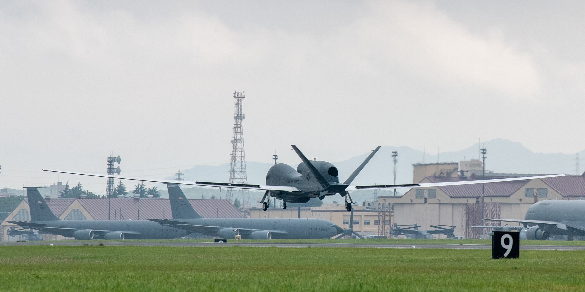 An RQ-4 Global Hawk, assigned to the 4th Reconnaissance Squadron, 319th Operation Group, Andersen Air Force Base, Guam, lands at Yokota Air Base, Japan, May, 22, 2021, for a rotational deployment. The movement maintains operations for Global Hawks during months of inclement weather on Guam. (U.S. Air Force photo by Yasuo Osakabe)