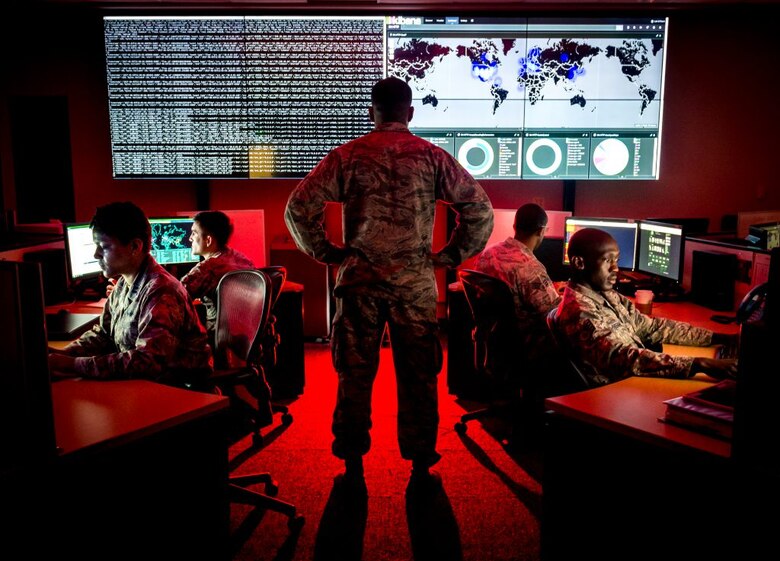 Capt. Taiwan Veney, cyber warfare operations officer, watches members of the 175th Cyberspace Operations Group, from left, Capt. Adelia McClain, Staff Sgt. Wendell Myler, Senior Airman Paul Pearson and Staff Sgt. Thacious Freeman, analyze log files and provide a cyber threat update utilizing a Kibana visualization on the large data wall in the Hunter’s Den at Warfield Air National Guard Base, Middle River, Md., June 3, 2017. (U.S. Air Force photo by J.M. Eddins Jr.)