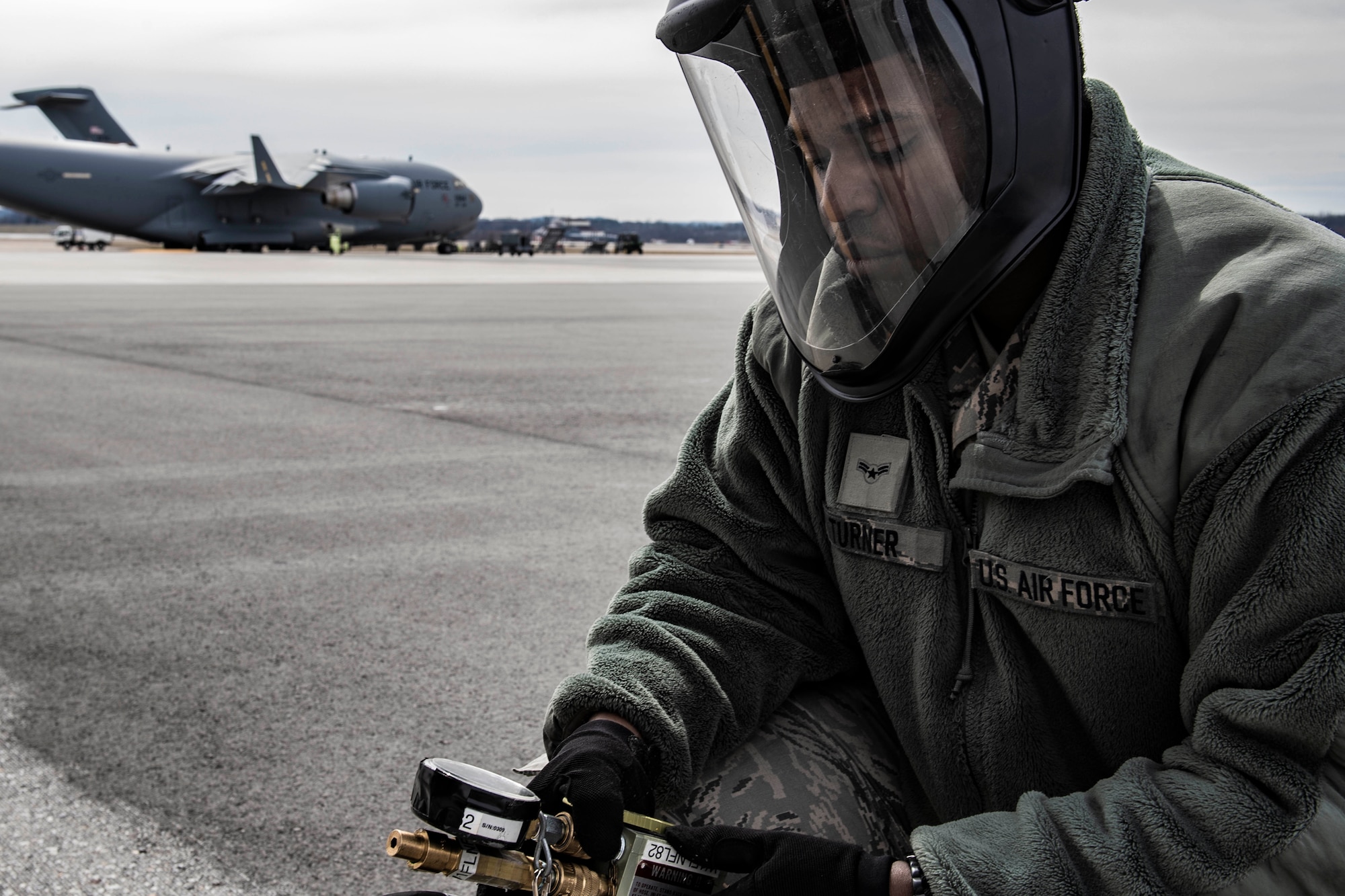 Airman 1st Class Elijah Turner, 911th Aircraft Maintenance Squadron crew chief, services a C-17 Globemaster III tire at the Pittsburgh International Airport Air Reserve Station, Pennsylvania, March 18, 2020. Crew chiefs perform a variety of tasks while working on the aircraft to ensure mission and operational readiness. (U.S. Air Force photo by Joshua J. Seybert)