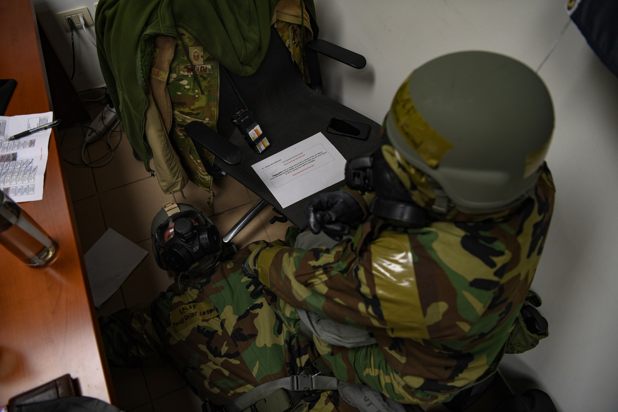 U.S. Air Force 2nd Lt. Thomas Townsend, right, 724th Air Mobility Squadron (AMS) operations flight commander, provides first aid to U.S. Air Force Master Sgt. Robert Latham, 724th AMS operations flight chief, during exercise Nodal Lightning at Aviano Air Base, Italy, May 18, 2021. Nodal Lightning is a readiness exercise for the 724th AMS to demonstrate how the team would operate in a contested environment. (U.S. Air Force photo by Airman 1st Class Thomas S. Keisler IV)