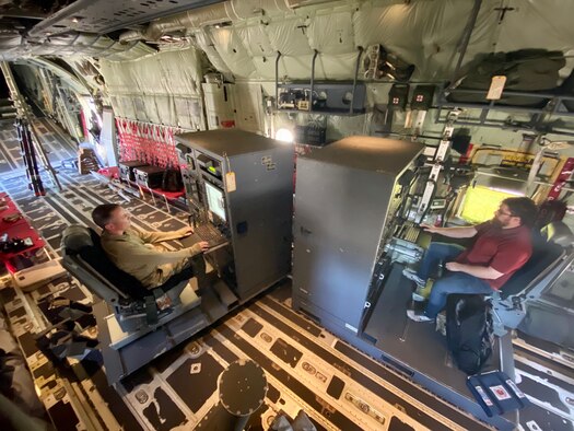 Tech. Sgt. Michael Gehl, 403rd Maintenance Squadron meteorology technician, and Bora Gunay, 580th Software Engineering Squadron test engineer, check the software on two aerial reconnaissance weather officer stations at Keesler Air Force Base, Miss., April 21, 2021. The 53rd Weather Reconnaissance Squadron “Hurricane Hunters’” ARWO and loadmaster/dropsonde operator stations are being upgraded with hardware and software to increase their weather collecting capabilities. (U.S. Air Force courtesy photo)