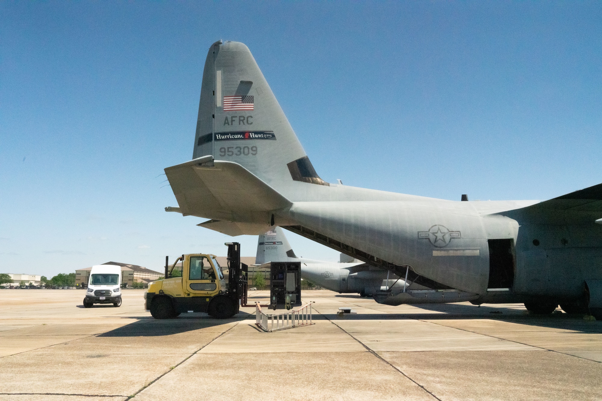 Master Sgt. Robert Ramos, 403rd Maintenance Squadron avionics flight chief, operates the forklift loading an aerial weather officer station onto a WC-130J Super Hercules aircraft at Keesler Air Force Base, Miss., May 13, 2021 The 53rd Weather Reconnaissance Squadron, “Hurricane Hunters,” ARWO and loadmaster/dropsonde operator stations are being upgraded with hardware and software to increase their weather collecting capabilities. (U.S. Air Force photo by 2nd Lt. Christopher Carranza)