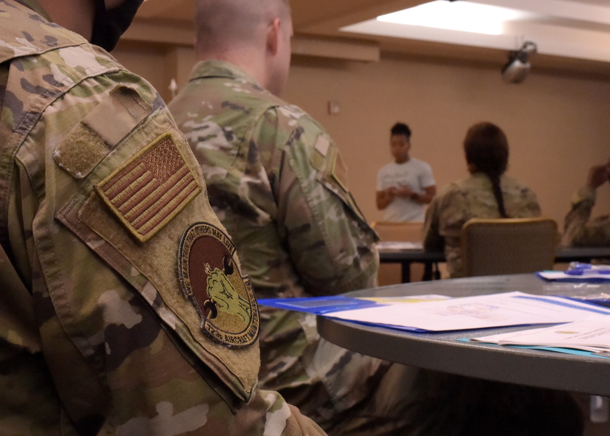 Airman watching a presenter during a briefing