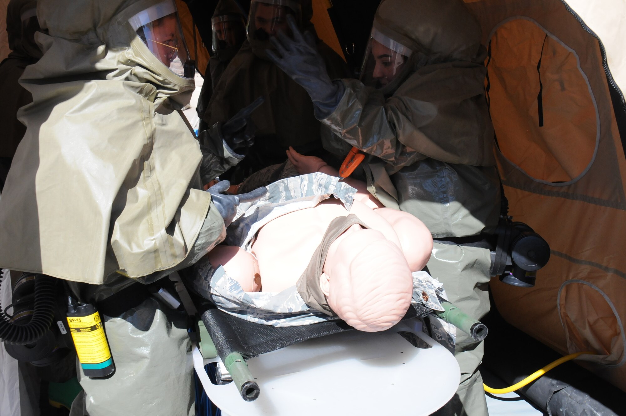 Military medical teams decontaminates a simulated patient