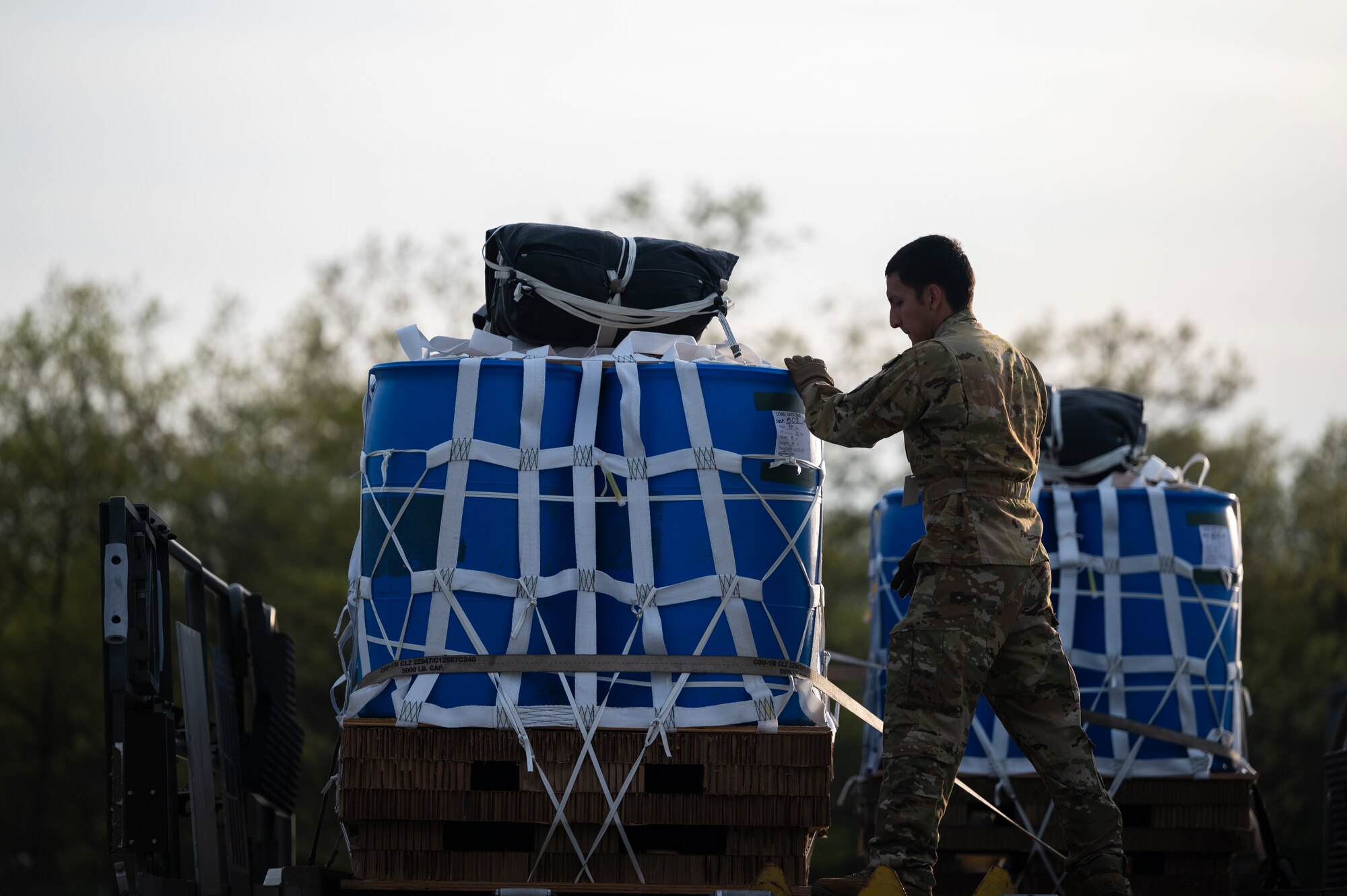 An Airman inspects a container delivery system
