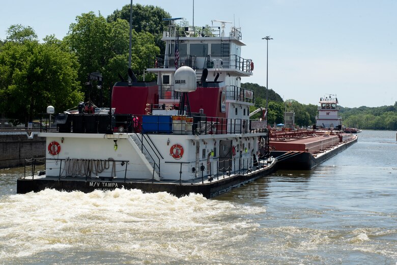 The Motor Vessel Tampa out of Ashland, Kentucky, and Motor Vessel Jess A. Mollineaux out of Nashville, Tennessee, guide Marathon Petroleum Company fuel barges May 21, 2021 out of Cheatham Lock in Ashland City headed to terminals in Nashville. The U.S. Army Corps of Engineers Nashville District worked with the fuel industry and Regional Rivers Repair Fleet, which is performing maintenance at the lock, to schedule openings to accommodate deliveries of fuel to Middle Tennessee. Each barge carries around 28,000 barrels of fuel. (USACE Photo by Lee Roberts)