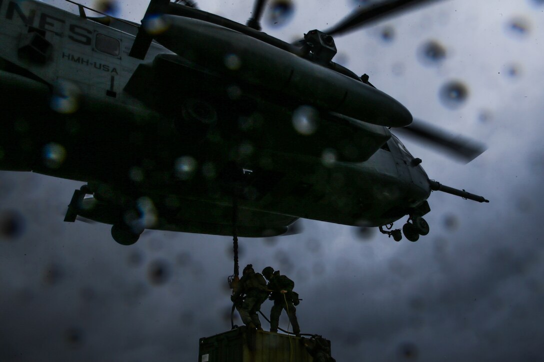 U.S. Marines with a Helicopter Support Team, Landing Support Battalion, Combat Logistics Regiment 3, 3d Marine Logistics Group, attach a quadcon to a CH-53 Super Stallion for transportation during exercise Pacific Pioneer at Torii Station, Okinawa, Japan, April 22, 2021. Pacific Pioneer serves as 9th Engineer Support Battalion's Marine Corps Combat Readiness Evaluation as well as an opportunity to demonstrate the ability to establish and sustain expeditionary advanced bases with survivable force protection, practice naval integration, and position long range precision fires and tactical logistics nodes across littoral regions in support of naval operations. 3d MLG, based out of Okinawa, Japan, is a forward deployed combat unit that serves as III MEF’s comprehensive logistics and combat service support backbone for operations throughout the Indo-Pacific area of responsibility. (U.S. Marine Corps photo by Sgt. Hailey D. Clay)
