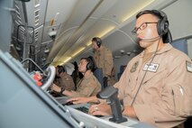 230521-N-IJ992-0157 U.S. 5TH FLEET AREA OF OPERATIONS (May 23, 2021) - Vice Adm. Brad Cooper, commander of U.S. Naval Forces Central Command, U.S. 5th Fleet and Combined Maritime Forces, center, operates mission systems of a P-8A Poseidon multi-mission maritime patrol and reconnaissance aircraft, attached to Patrol Squadron 4, deployed with Commander, Task Force (CTF) 57, while operating in the U.S. 5th Fleet area of operations, May 23. CTF 57 aircraft conduct missions in support of maritime operations to ensure stability, security, and the free flow of commerce in the Central Command area of responsibility, which connects the Mediterranean and Pacific through the western Indian Ocean, encompassing three strategic chokepoints. (U.S. Navy photo by Mass Communication Specialist Seaman Andy A. Anderson)
