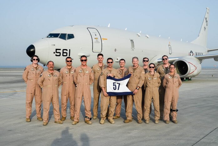 230521-N-IJ992-0401 U.S. 5TH FLEET AREA OF OPERATIONS (May 23, 2021) - Vice Adm. Brad Cooper, commander of U.S. Naval Forces Central Command, U.S. 5th Fleet and Combined Maritime Forces, center left, Capt. James Johnston, commander, Task Force (CTF) 57, center right, and Patrol Squadron 4 air crew members pose for a group photo in front of a P-8A Poseidon multi-mission maritime patrol and reconnaissance aircraft in the U.S. 5th Fleet area of operations, May 23. CTF 57 aircraft conduct missions in support of maritime operations to ensure stability, security, and the free flow of commerce in the Central Command area of responsibility, which connects the Mediterranean and Pacific through the western Indian Ocean, encompassing three strategic chokepoints. (U.S. Navy photo by Mass Communication Specialist Seaman Andy A. Anderson)