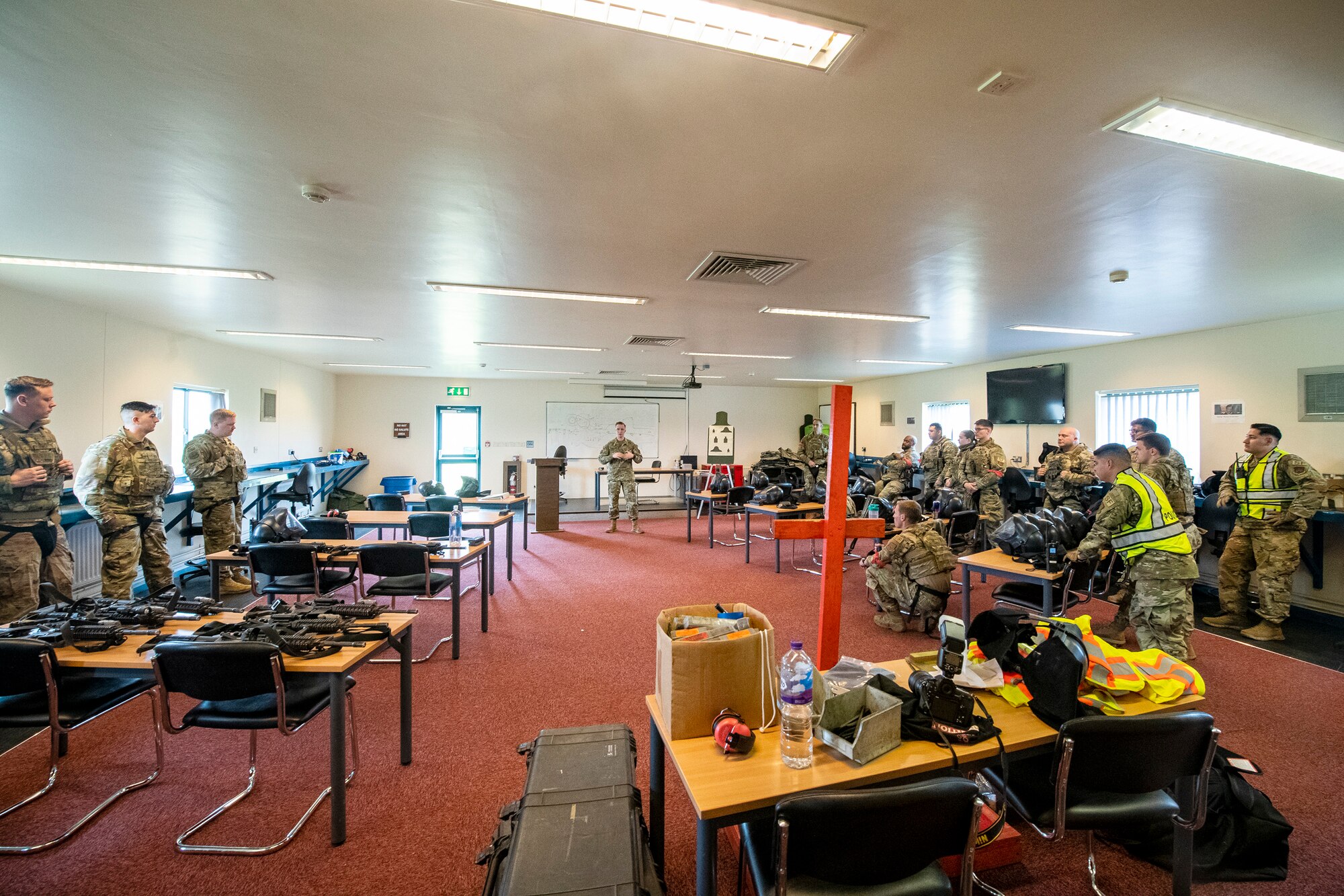 Airmen from the 422d and 423rd Security Forces Squadrons, listen to a briefing prior to a Force-on-Force exercise at RAF Molesworth, England, May 21, 2021. Defenders from the 422d and 423rd SFS came together to sharpen their shoot, move, communicate tactics as they responded to multiple scenarios geared towards sharpening their skills in deadly force situations. (U.S. Air Force photo by Senior Airman Eugene Oliver)