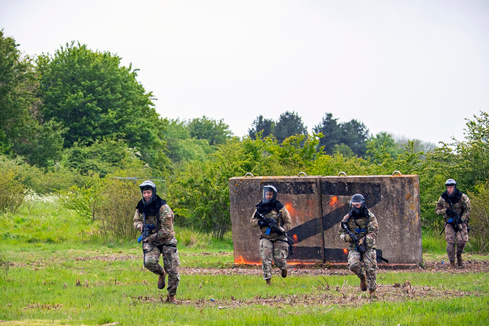 Airmen from the 423rd Security Forces Squadron, advance their position during a Force-on-Force exercise at RAF Molesworth, England, May 21, 2021. Defenders from the 422d and 423rd SFS came together to sharpen their shoot, move, communicate tactics as they responded to multiple scenarios geared towards sharpening their skills in deadly force situations. (U.S. Air Force photo by Senior Airman Eugene Oliver)