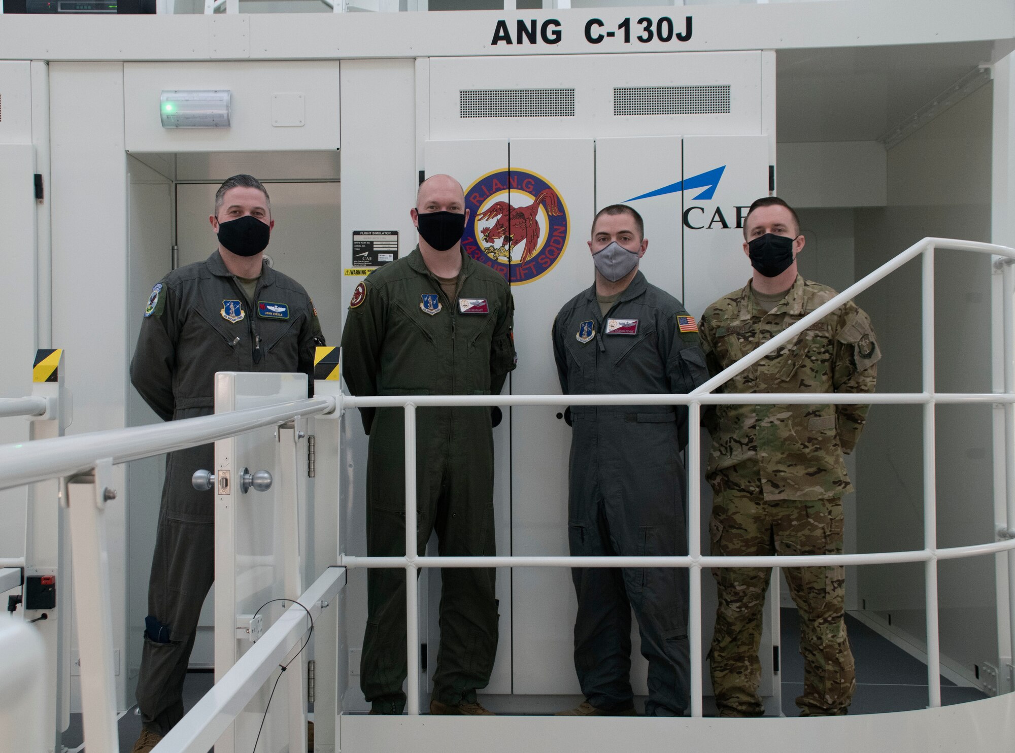 From left, Air National Guard pilots, Maj. Mark Zirkle, from the 130th Airlift Squadron, and Lt. Col. Rob Gearhart, and loadmasters, Master Sgts. Graham Devine and Nick Dislavo, from the 143d Airlift Wing, take part in the first training class of the Weapons Systems Trainer-Reconfigurable, at Quonset Air National Guard Base, North Kingstown, R.I., May 7, 2021. The WST10R allows crewmembers to maintain currency and stay at a higher level or readiness. (U.S. Air National Guard photo by Airman 1st Class Brittni Capozzi)