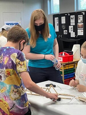 Transatlantic Middle East District Fire Protection Engineer Katie Render discussion the bridge design criteria with students at a recent STARBASE Academy Winchester presentation.