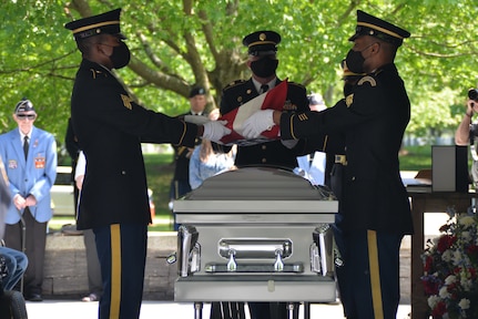 New York Army National Guard Military Forces Honor Guard members Sgt. Stanley Paul, left, Staff Sgt. Joshua Sanzo, right, and Staff Sgt. Kenval Small, fold the flag as they render final honors to Korean War MIA Cpl. Clifford Johnson during his funeral ceremony May 20, 2021, at the Gerald B.H. Solomon Saratoga National Cemetery in Schuylerville, N.Y. Johnson returned home after more than 70 years listed as missing in action following his death in North Korea near the Chosin Reservoir in December 1950.