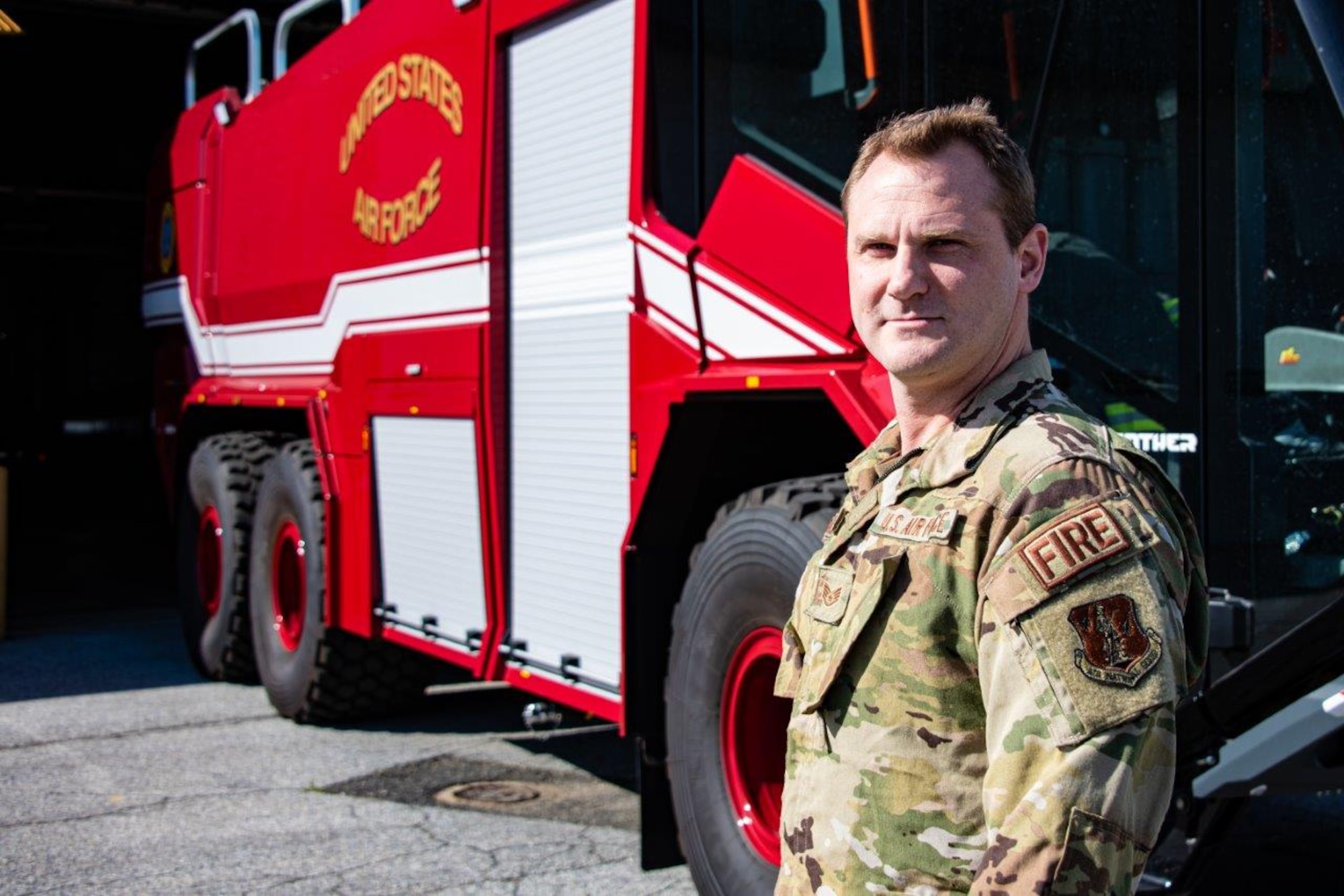 NEW CASTLE AIR NATIONAL GUARD BASE, Del.— Staff Sgt. Alfred Akeroyd a firefighter with the 166th Civil Engineer Squadron stands outside Station 33 with their new P-23 crash truck, 12-May-2020. Staff Sgt. Akeroyd deployed to the Baghdad, Iraq air base to train Iraqi firefighters from November 2019 through April 2020. During his deployment, Akeroyd endured numerous rocket and mortar attacks from rebel extremists while working as an air advisor to the Iraqi military. (U.S. Air National Guard photo by Mr. Mitch Topal)