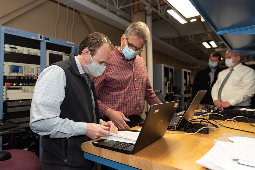 Photo of representatives from Tobyhanna Army Depot working with L3Harris Technologies personnel.