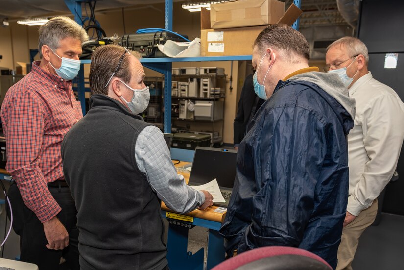 Photo of representatives from Tobyhanna Army Depot working with L3Harris Technologies personnel.