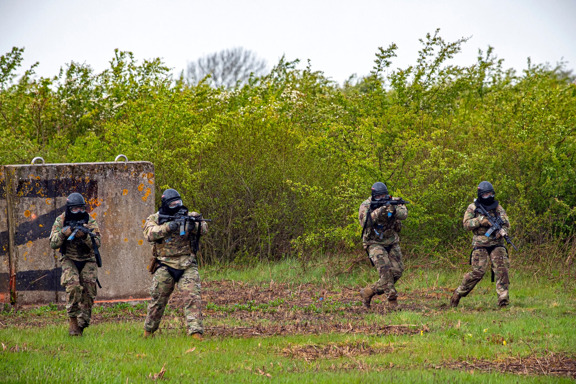 Airmen from the 422d Security Forces Squadron, advance their position while applying cover fire during a Force-on-Force exercise at RAF Molesworth, England, May 21, 2021. Defenders from the 422d and 423rd SFS came together to sharpen their shoot, move, communicate tactics as they responded to multiple scenarios geared towards sharpening their skills in deadly force situations. (U.S. Air Force photo by Senior Airman Eugene Oliver)