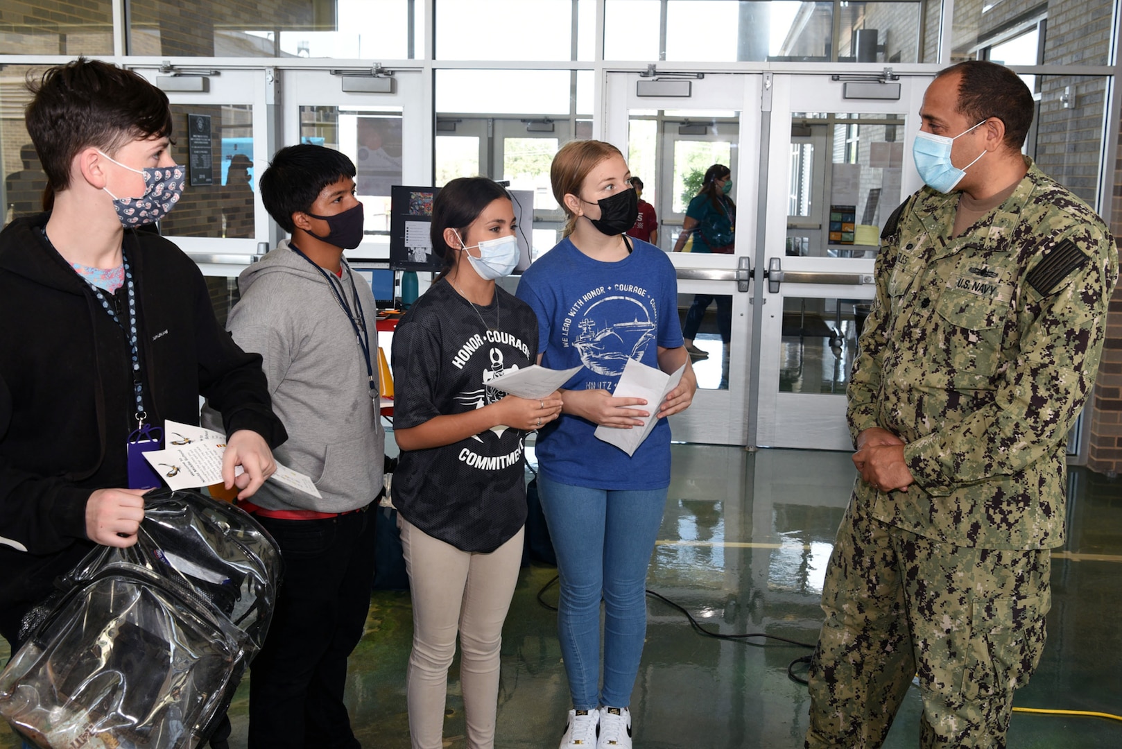 Military person speaking to students