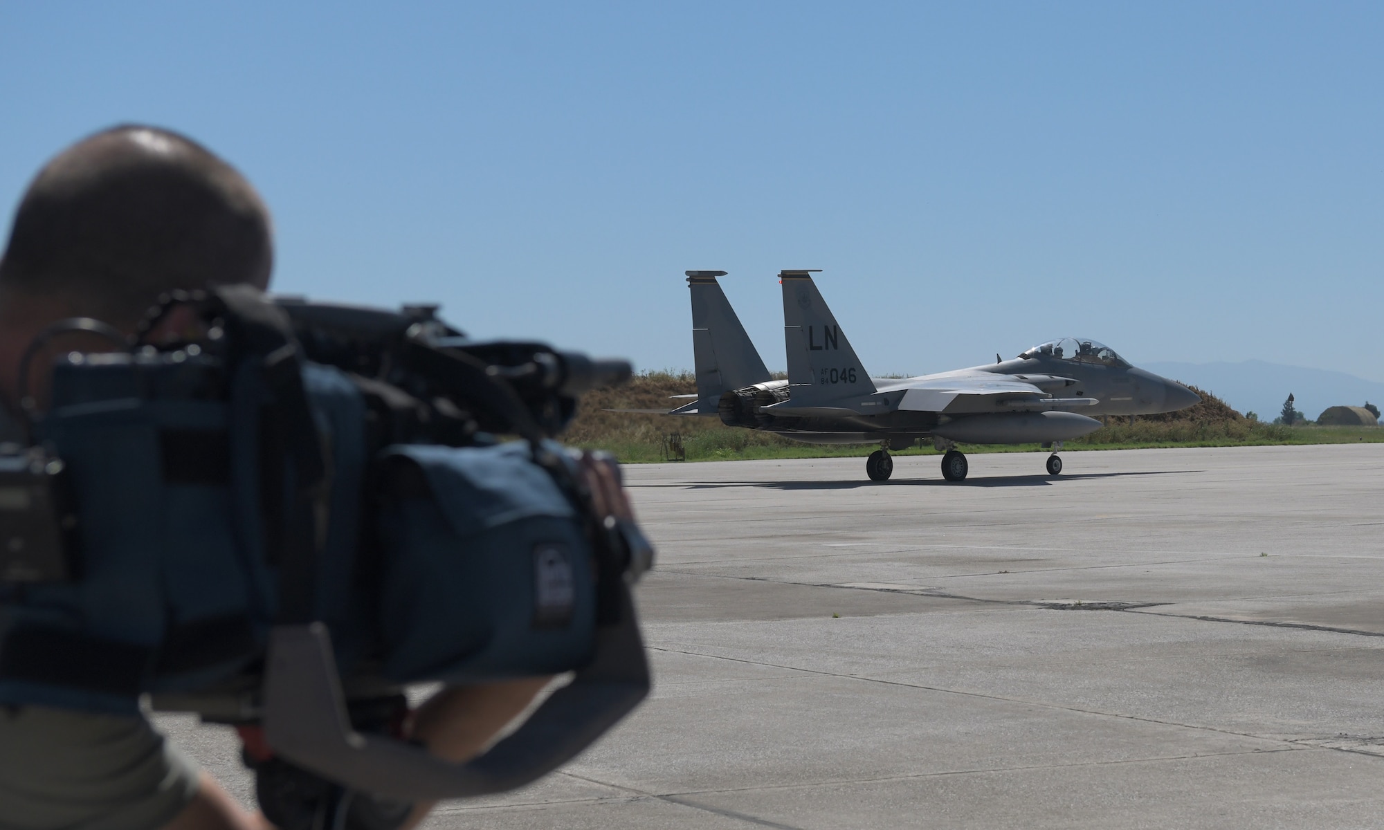 Local media films a U.S. Air Force F-15C Eagle assigned to the 493rd Fighter Squadron during exercise Astral Knight 21 at Larissa Air Base, Greece, May 19, 2021. The 48th Fighter Wing trained with military forces from Albania, Croatia, Greece, Italy, and Slovenia as well as U.S. units from around European Command enhancing the readiness, strength and cohesion of these alliances. (U.S. Air Force photo by Tech. Sgt. Alex Fox Echols III)