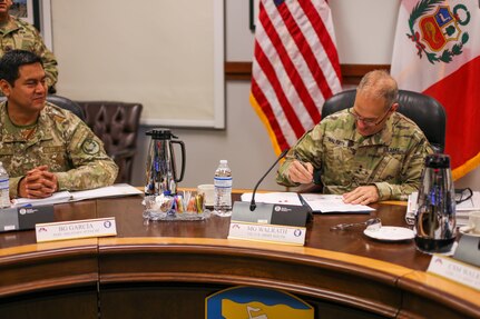 Maj. Gen. Daniel R. Walrath, U.S. Army South commanding general, signs minutes during the sixth annual U.S., Peru army-to-army staff talks, May 20, at the Army South headquarters, Fort Sam Houston, Texas.