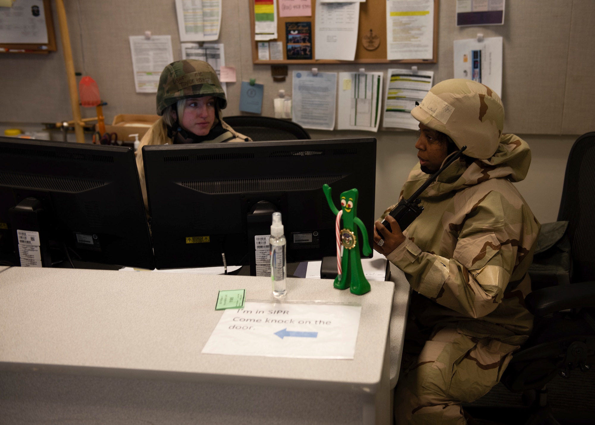 Two Airmen are working on maintenance personnel accountability by looking at a computer.