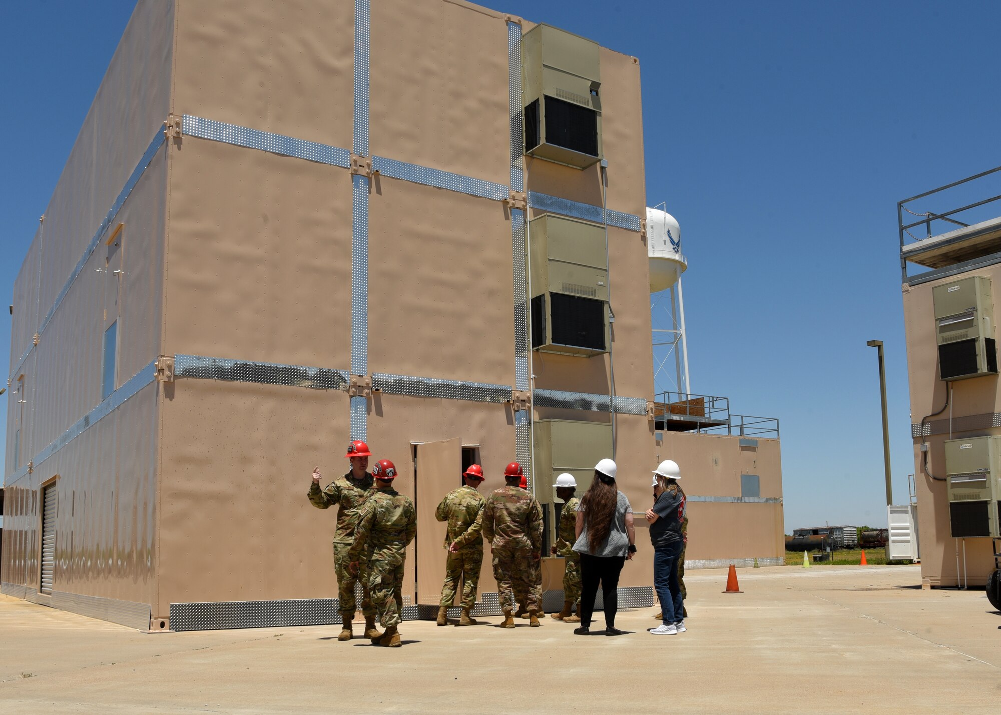 Members of Goodfellow tour new training facilities at the Louis F. Garland Department of Defense Fire Academy on Goodfellow Air Force Base, Texas, May 21, 2021. The new facilities integrated advanced technologies, which created more realistic fire scenarios and modernized the training environment. (U.S. Air Force photo by Senior Airman Abbey Rieves)