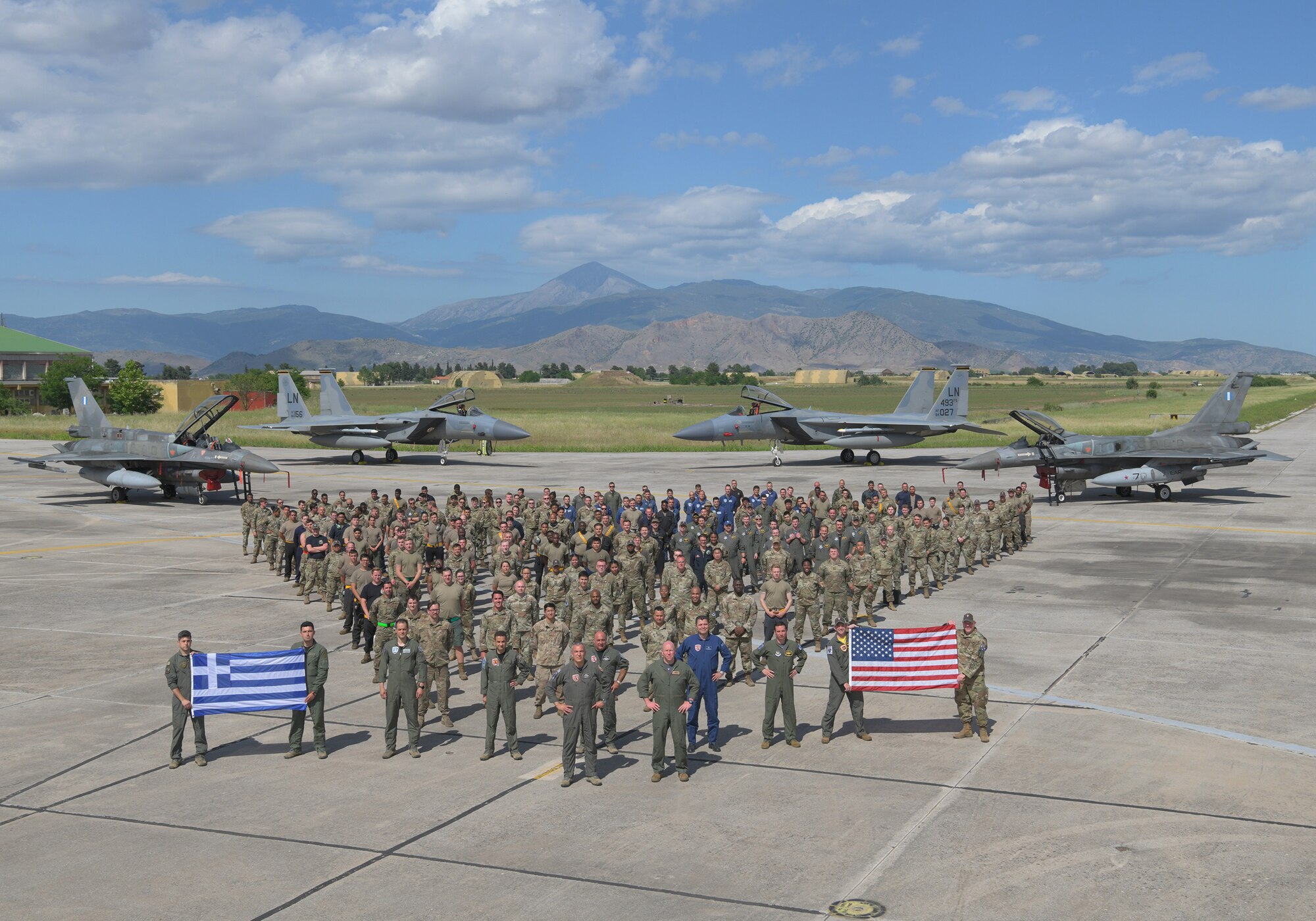 U.S. Air Force and Hellenic Air Force personnel join together at the conclusion of exercise Astral Knight, May 21, 2021. The 48th Fighter Wing trained with military forces from Albania, Croatia, Greece, Italy, and Slovenia as well as U.S. units from around European Command enhancing the readiness, strength and cohesion of these alliances. (U.S. Air Force photo by Tech. Sgt. Alex Fox Echols III)