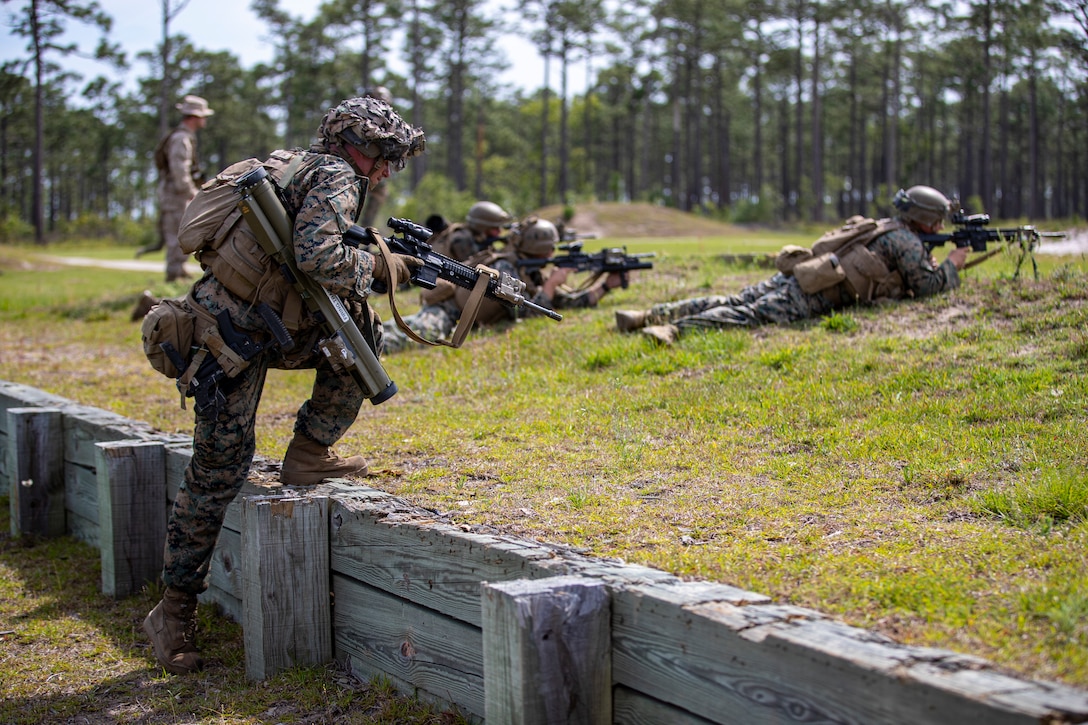 U.S. Marine Corps Pfc. Alexander Carson, a native of Daytona Beach, Fla. and a grenadier with Echo Company, 2d Battalion, 8th Marine Regiment, 2d Marine Division, advances to assault a target on a company battle course on range G-36, Camp Lejeune, N.C., May 22, 2021. Echo Company executed the battle course in the daytime and nighttime, with Marines from 2d Marine Regiment evaluating their performance. The event is the culmination of their Marine Corps Combat Readiness Evaluation, certifying the unit as an apex battalion. (U.S. Marine Corps photo by Lance Cpl. Jacqueline Parsons)
