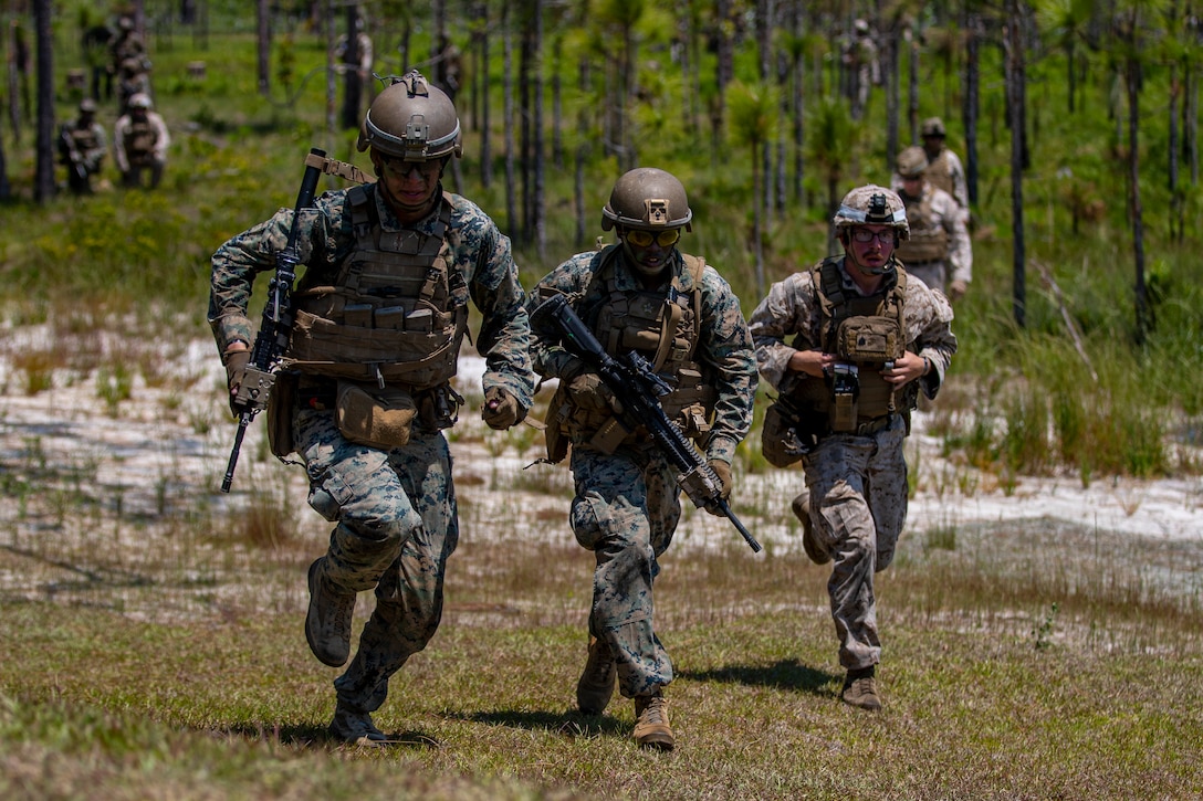 U.S. Marines with Echo Company, 2d Battalion, 8th Marine Regiment, and 2d Marine Regiment, 2d Marine Division, advance to an objective on a company battle course on range G-36, Camp Lejeune, N.C., May 23, 2021. Echo Company executed the battle course in the daytime and nighttime, with Marines from 2d Marine Regiment evaluating their performance. The event is the culmination of their Marine Corps Combat Readiness Evaluation, certifying the unit as an apex battalion. (U.S. Marine Corps photo by Lance Cpl. Jacqueline Parsons)