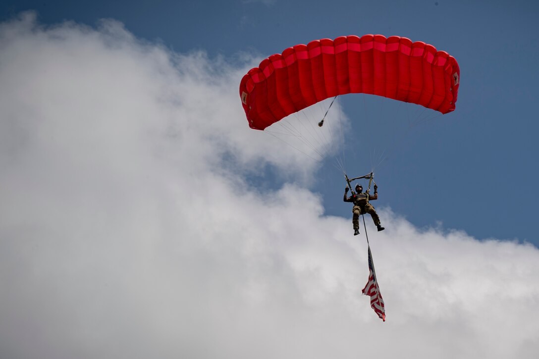 Photo of an Airman descending into a drop zone