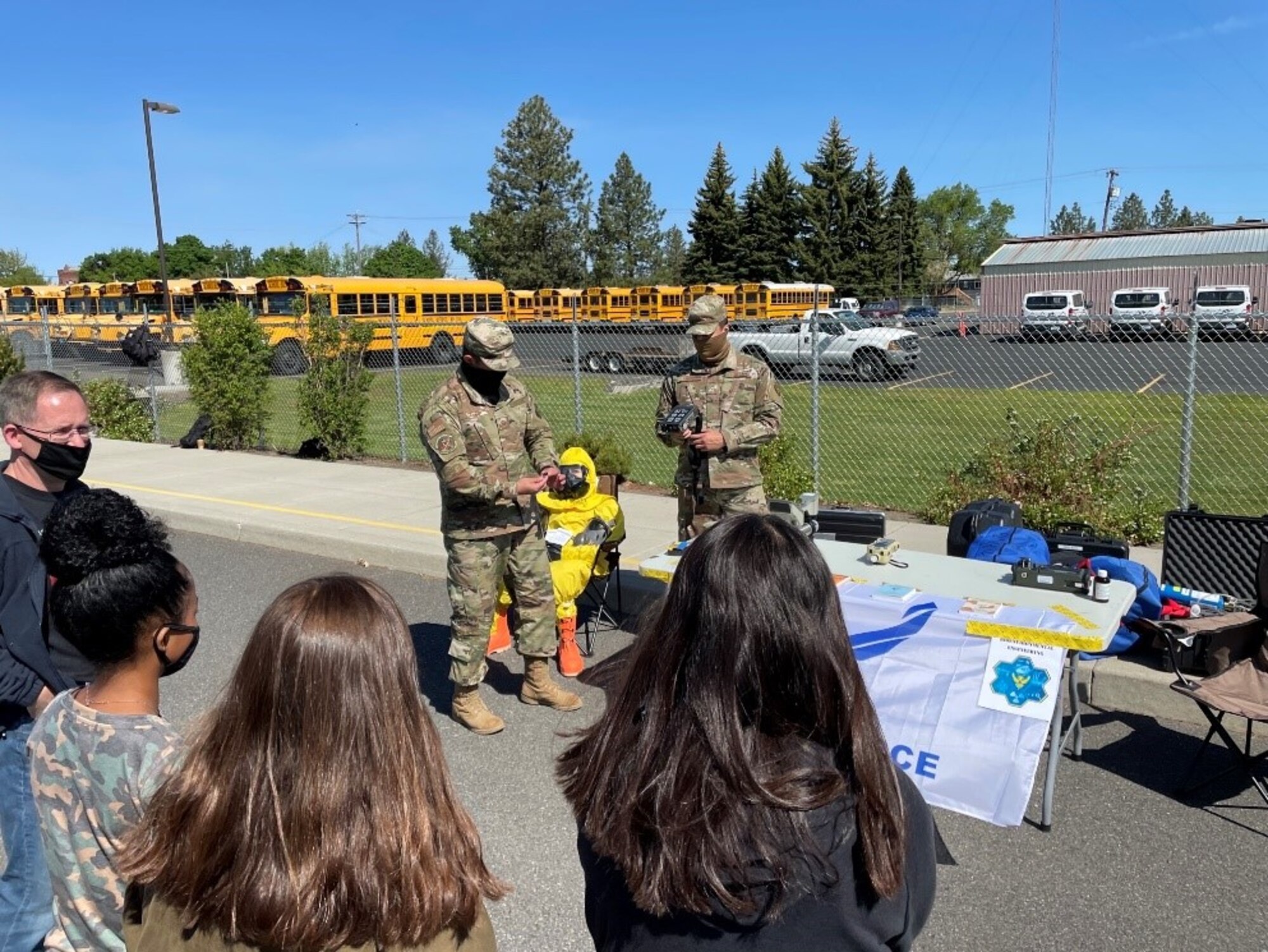 Staff Sergeant Gerardo Salas, 92nd Bioenvironmental Engineering bioenvironmental engineering craftsman, and Airman Isaiah Gomez, 92nd Bioenvironmental Engineering bioenvironmental engineering apprentice brief students from Medical Lake Middle School on technology they use to help keep Team Fairchild safe from potentially harmful substances, May 21, 2021.