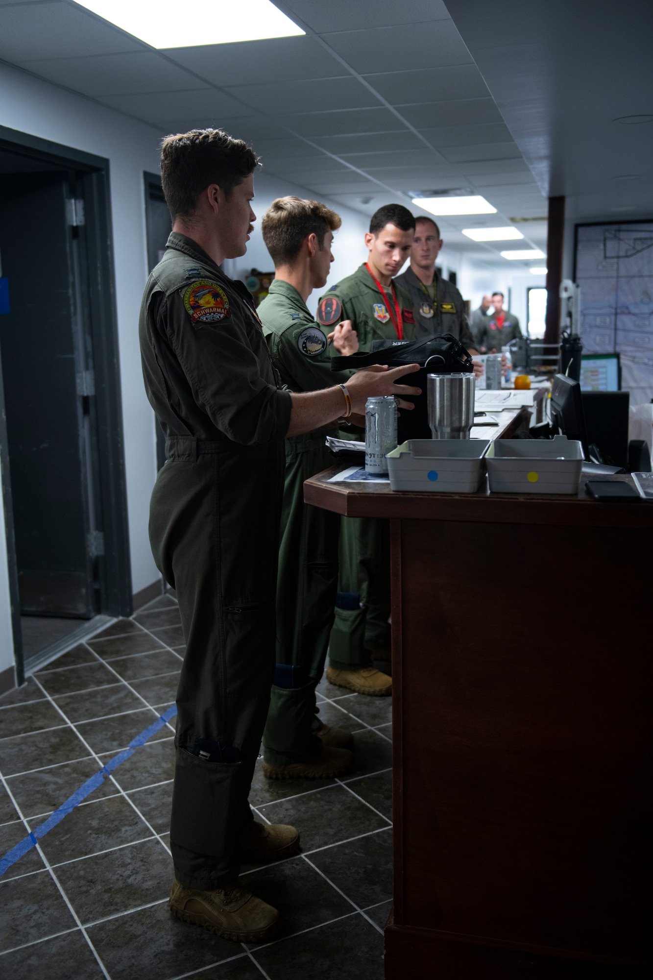 Men standing at a desk